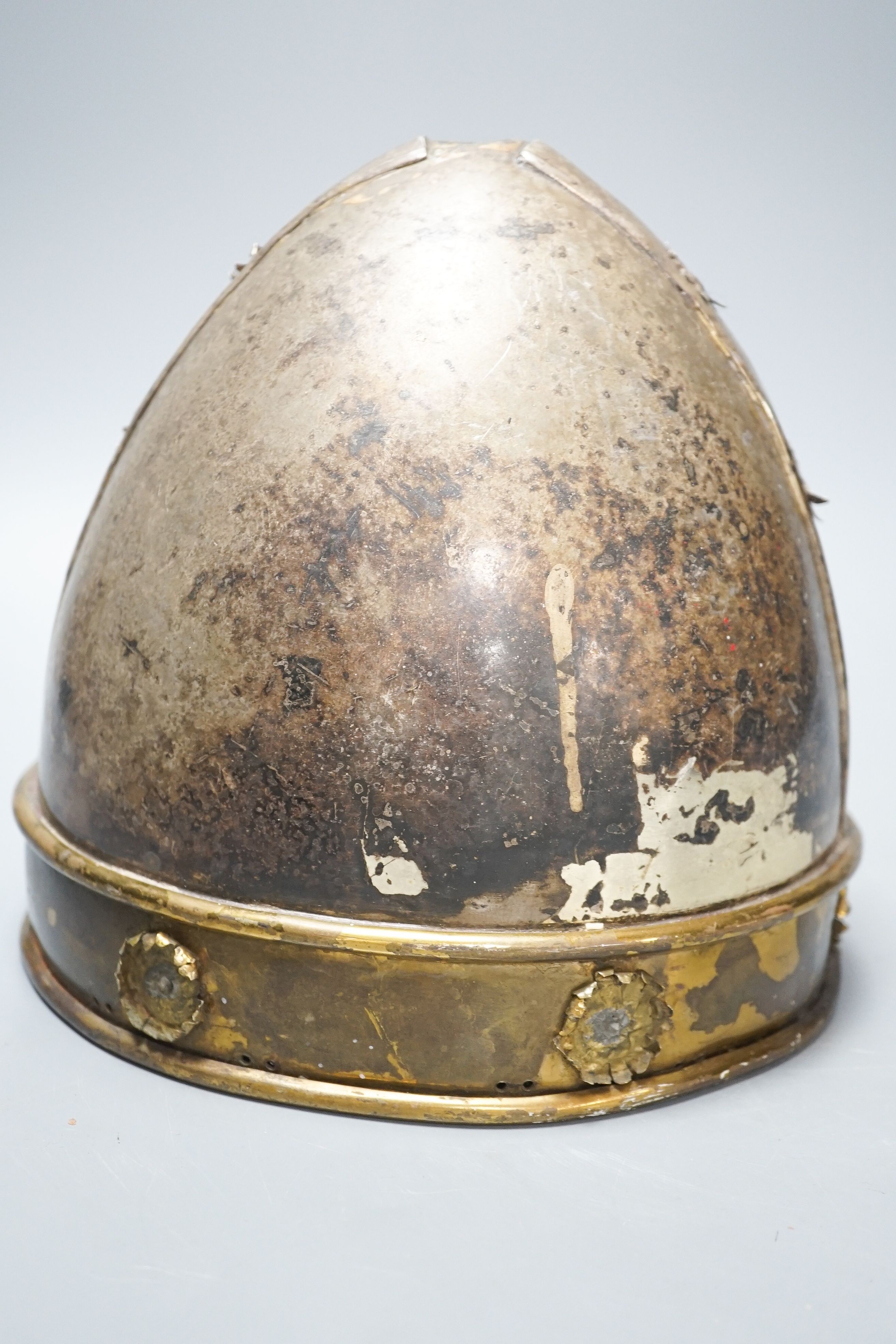 A Middle-Eastern silvered metal and brass helmet and a dagger in sheath